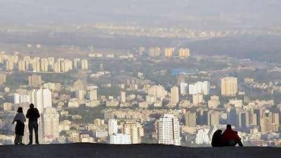 Visitors enjoy the view of northern Tehran from Mount Tochal, a ski resort at an elevation of 3,964 metres.