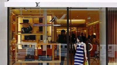 A woman exits from the Louis Vuitton shop on New Bond Street, renowned for its jewellery and designer retailers, in London in this file photo taken August 24, 2009. Rich Chinese tourists paying $40,000 to hunt elk in Utah or booking the entire first-class cabin for a family flight to France show China's economic slowdown has yet to thin the wallets or dull the appetites of its deep-pocketed elite. REUTERS/Luke MacGregor/Files (BRITAIN - Tags: BUSINESS SOCIETY) *** Local Caption *** TOR906_CHINA LUXURY_0927_11.JPG