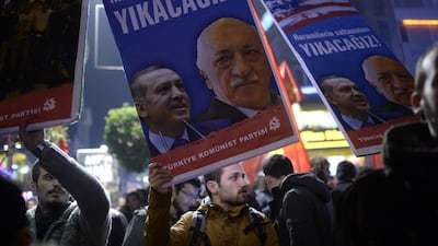 A protester holds up a placard with pictures of the Turkish prime minister Recep Tayyip Erdogan, left, and the cleric Fethullah Gülen, reading ‘We will cast them down’, during a demonstration in Istanbul in December. AFP / Bulent Kilic