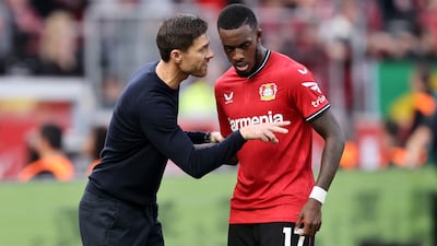 Leverkusen coach Xabi Alonso speaks with on-loan midfielder Callum Hudson-Odoi during the Bundesliga match against Schalke 04 at BayArena on October 08, 2022. Getty Images