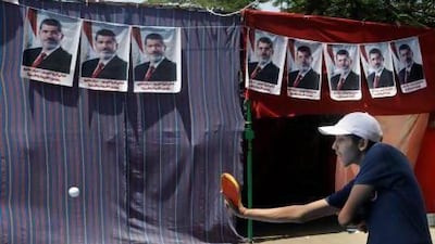 Supporters of Egypt's ousted President Mohammed Morsi play ping pong at their camp in Nahda Square, near Cairo University in Giza, southwestern Cairo.