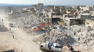 Machinery operates at the site of damaged buildings following an earthquake in the rebel-held town of Harem, Syria. Reuters