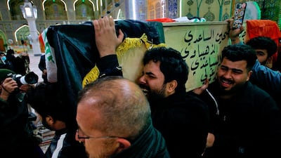 Mourners carry a flag-draped coffin of a suicide bomb victim, Ahmed Reda, during his funeral procession at the Imam Ali shrine in Najaf, Iraq. AP
