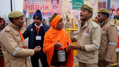 Police officers ask a Hindu holy man to leave the area before the inauguration in Ayodhya. Reuters