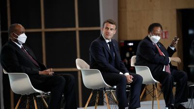 French President Emmanuel Macron, center, Sudan's Prime Minister Prime Minister of Sudan Abdallah Hamdok, right, and Gen. Abdel-Fattah Burhan, head of Sudan's ruling sovereign council attend a session of the summit to support Sudan. AP Photo