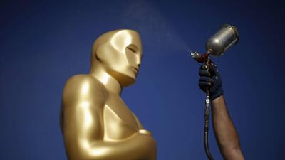 A worker spray paints an Oscar statue outside the Dolby Theatre for the 88th Academy Awards in Hollywood, Los Angeles. Lucy Nicholson / Reuters