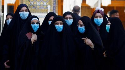 Women wear protective face masks at Imam Ali Shrine in the holy city of Najaf, Iraq March 11, 2020. Reuters