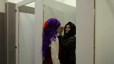A woman applies makeup on a contestant in a costume competition at EgyCon, an annual convention for comics enthusiasts, in Cairo. AP Photo