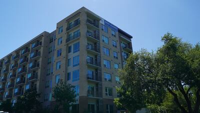 A 'now leasing' sign hangs from an apartment complex in Austin.