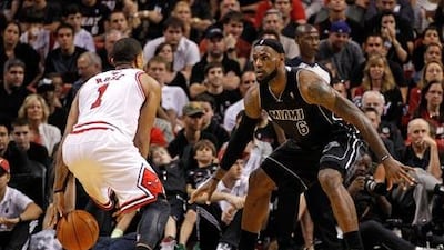 Derrick Rose, left, missed chances to win the match for the Chicago Bulls against Miami Heat and LeBron James, right,
