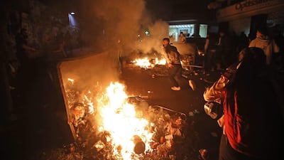 Lebanese students burn dumpsters while protesting a decision by top universities to adopt a new dollar exchange rate to price tuition in Beirut's Hamra district. AFP
