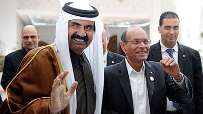 The emir of Qatar Sheikh Hamad bin Khalifa Al Thani is greeted by the Tunisian president, Moncef Marzouki, right, during a visit to Tunis last weekend for the one-year commemoration of Zine El Abidine Ben Ali’s fall. He was joined by dignitaries from the UAE, Libya, Algeria, Morocco and elsewhere.