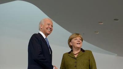 In this file photo taken on February 1, 2013, Joe Biden and Angela Merkel shake hands at the Chancellery in Berlin. AFP