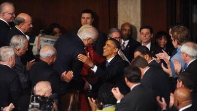 President Barack Obama greets members of Congress before delivering his second State of the Union address.