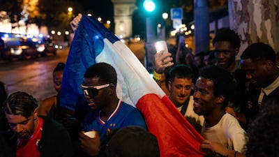 French fans celebrate on the Champs-Elysees in Paris after beating Morocco on July 10. EPA
