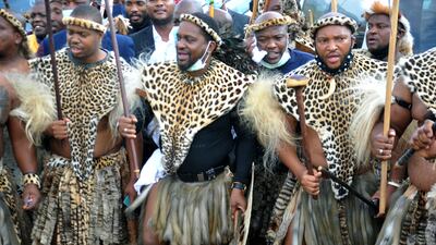 King Misuzulu Zulu, centre, with fellow warriors in traditional dress at the KwaKhangelamankengane Royal Palace in Nongoma, South Africa. AP