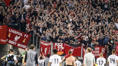 Liverpool players celebrate with fans after the match. Fabio Frustaci / EPA