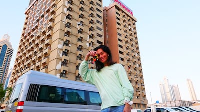 One of the participants has her photo taken in front of the building.
