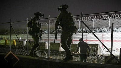 UK and Canadian troops stand guard at Kabul airport, where thousands of people are hoping to board flights out of Afghanistan following the Taliban takeover. Photo: AFP