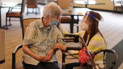 Pat Fischer, 94, talks to Marguerite Crockem before receiving the coronavirus disease vaccine at the Brightwater Senior Living community in Highland, California. Reuters