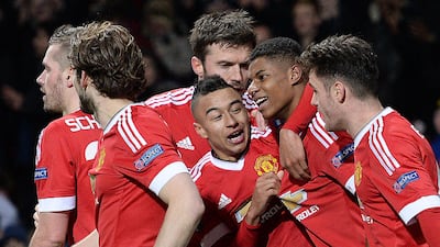 Marcus Rashford is mobbed by teammates after scoring his United's third goal. AFP