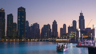 Tourists take a boat ride at the Burj Khalifa lake in Dubai. Satish Kumar / The National
