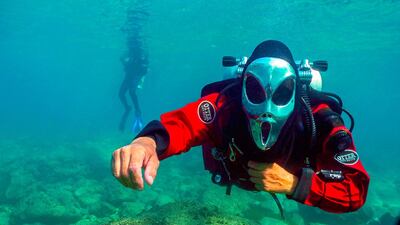 Divers in Halloween masks dive off the coast of Batroun city in Lebanon. AFP