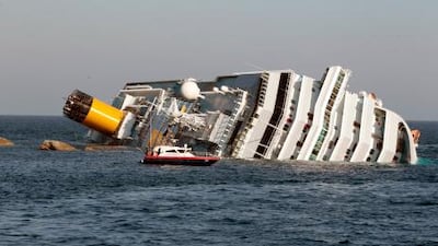 A Carabinieri boat approaches the luxury cruise ship Costa Concordia that ran aground near the tiny Tuscan island of Giglio today.