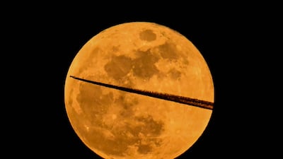 A plane flies past the Blood Moon over Frankfurt. AFP