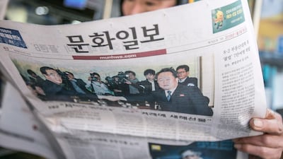 A man reads a newspaper featuring a photograph of Cho Myoung-gyon, South Korea's unification minister (L), shaking hands with Ri Son Gwon, chairman of North Korea’s Committee for the Peaceful Reunification of the Fatherland, on its front page in Seoul, South Korea, on Tuesday. Jean Chung / Bloomberg