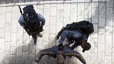 Israeli border police frisk a suspected Palestinians youth next to the Damascus Gate of the Old City of Jerusalem. Atef Safadi / EPA