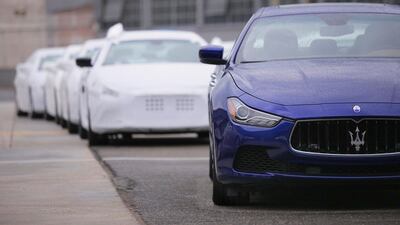 Several Maserati Quattroporte are parked outside a Maserati plant on May 22, 2014 in Grugliasco, near Turin. MARCO BERTORELLO / AFP