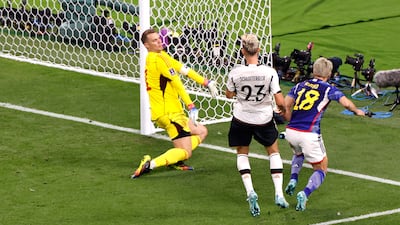 Takuma Asano (R) of Japan scores the second goal of his team against German goalkeeper Manuel Neuer. EPA