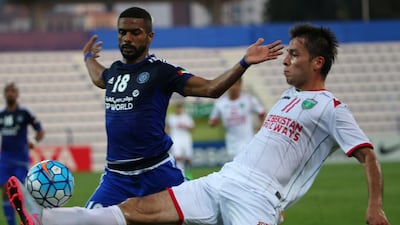 Temurkhuja Abdukholikov (R) of Uzbekistan’s Lokomotiv club vies for the ball against Ahmed Al-Yassi of UAE’s Al-Nasr club player Khalid Jalal during their AFC Champions League group A match in Dubai on April 20, 2016. / AFP / MARWAN NAAMANI