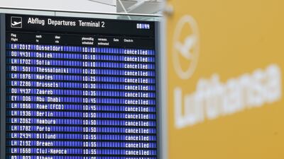 Flight information boards display cancelled flights at Munich International Airport. Bloomberg