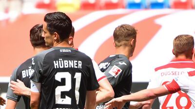 Dusseldorf's Kaan Ayhan falls to the ground after being hit in the face by Benjamin Huebner - the Hoffenheim player was sent-off as a result. AFP