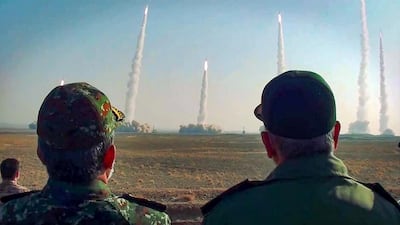 The head of Iran's Revolutionary Guard Corps Hossein Salami, right, watches the launch of missiles during a military drill in an unknown location in central Iran. Sepah News / AFP