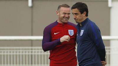 England’s Wayne Rooney and Gary Neville during training. REUTERS/Lee Smith
