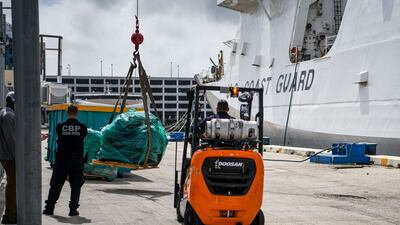 US Coast Guard personnel offload about $1bn in cocaine and marijuana from the deck of cutter 'James' at Port Everglades in Fort Lauderdale, Florida, on February 17. AFP