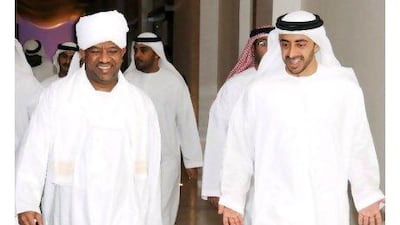 Sheikh Abdullah bin Zayed, the Foreign Minister of the UAE, right, with Sudan's minister of state for foreign affairs, Kamal Hassan Ali, in Abu Dhabi yesterday.