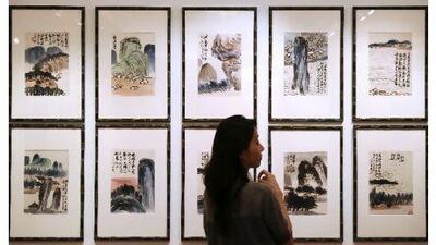 The Chinese artist Qi Baishi's Landscapes is displayed at a China Guardian auction preview in Hong Kong last month, where total sales hit 1.75 billion yuan. Dale de la Rey / AFP