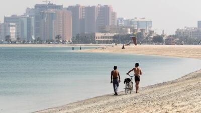 Residents walk along the Mamzar beach, Dubai. Pawan Singh