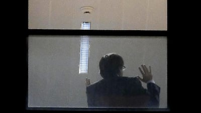 A man believed to be Carles Puigdemont gestures inside the public prosecutor's office in Brussels. Catalonia's sacked separatist leader Carles Puigdemont and four of his former ministers turned themselves in to Belgian police after Spain issued a warrant for their arrest. Nicolas Maeterlinck / AFP Photo / November 5, 2017