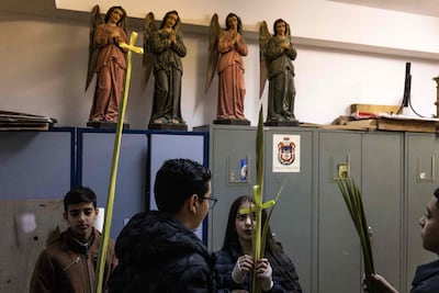 Altar servers hold palm fonds ahead of Palm Sunday Mass, commemorating Jesus Christ’s entry into Jerusalem, at the Catholic Franciscan Monastery of Saint Saviour in the old city of Jerusalem on March 29, 2026. AFP