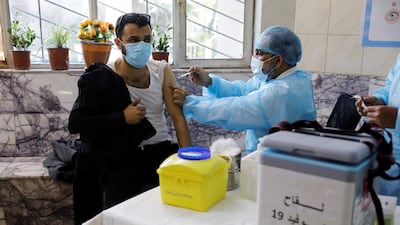 A man receives a vaccine against the coronavirus disease in Baghdad. Reuters