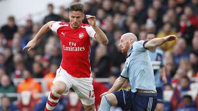 Arsenal's Olivier Giroud in action with West Ham's James Collins. Reuters