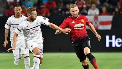 Manchester United's Luke Shaw moves the ball past AC Milan's Ignazio Abate. Reuters