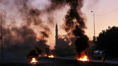 Anti-government protesters set fires and close a street during a demonstration in Baghdad, Iraq. AP