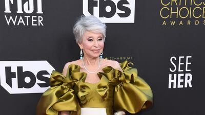 Puerto Rican actress Rita Moreno in a dramatic ruffled olive and white gown. AFP