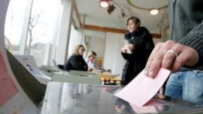 A man casts his ballot in Uster, near Zurich, in a vote that saw an initiative by the anti-immigrant Swiss People's Party win acceptance.